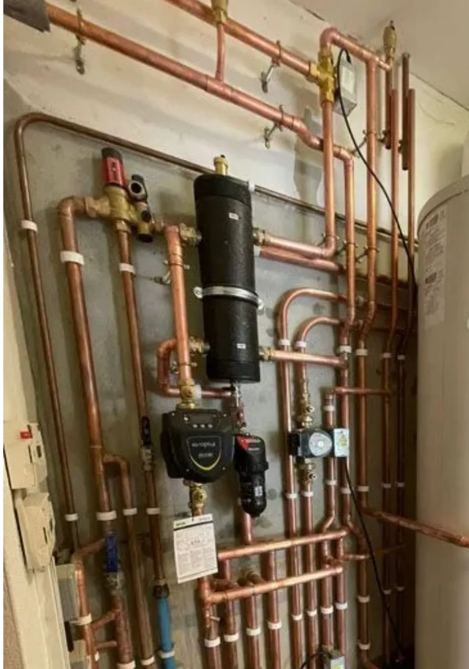 Complex copper pipework feeding a central heating and hot water system